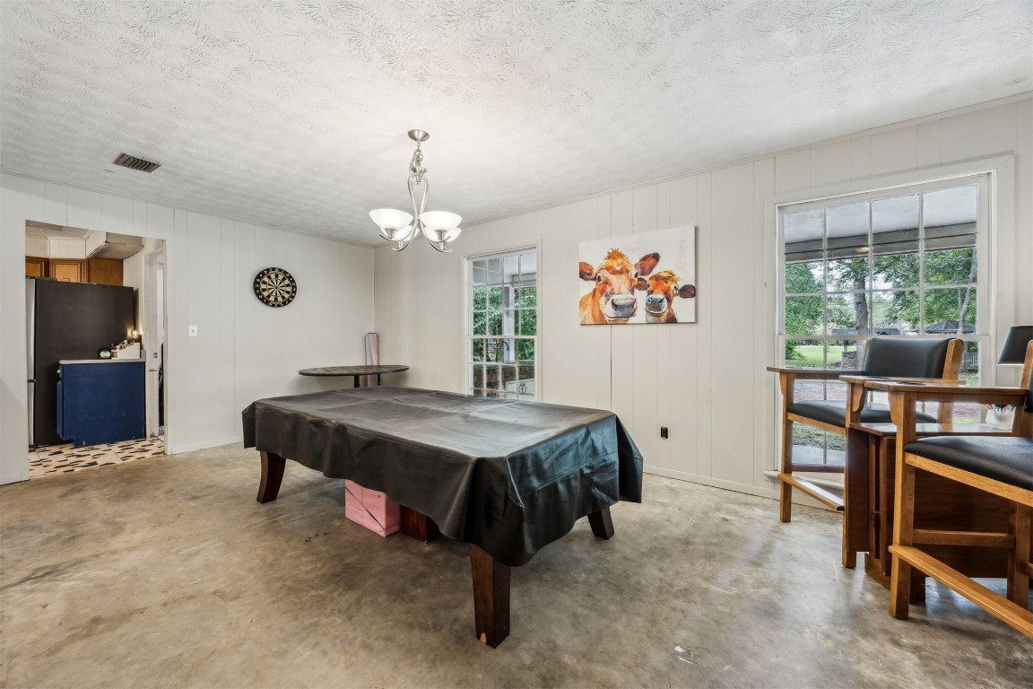 86071 Jones Road Yulee, FL 32097 - Photo 19 of 44 a bedroom with a bed and a chandelier