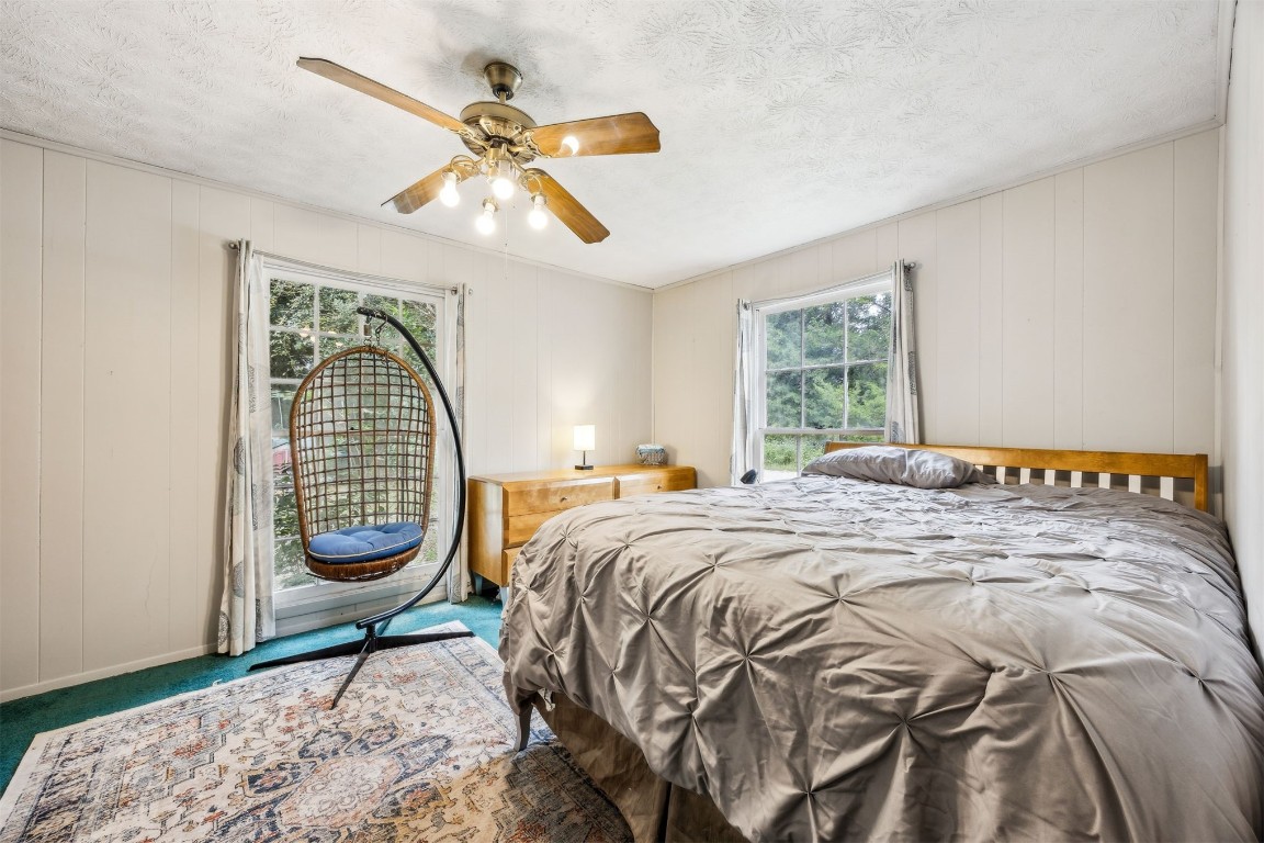 86071 Jones Road Yulee, FL 32097 - Photo 32 of 44 a bedroom with a bed a chandelier and a window