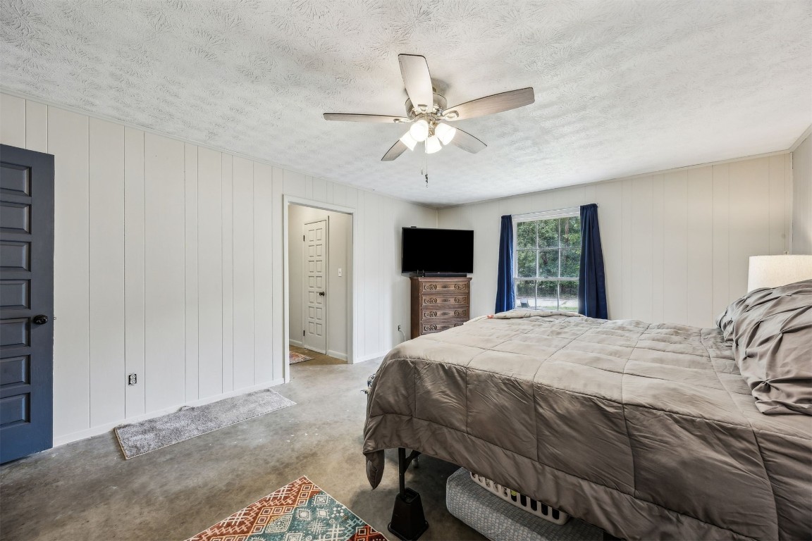 86071 Jones Road Yulee, FL 32097 - Photo 35 of 44 a bedroom with a large bed and a flat tv screen