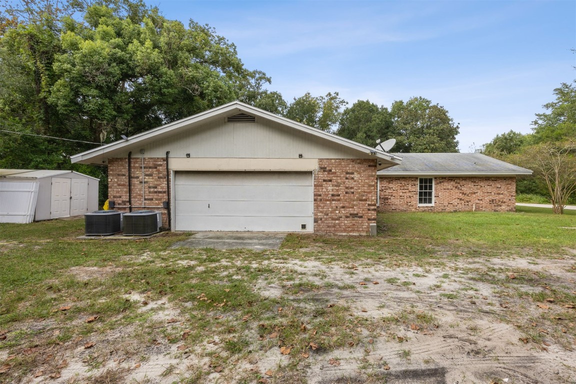 86071 Jones Road Yulee, FL 32097 - Photo 42 of 44 a view of a house with a yard and garage