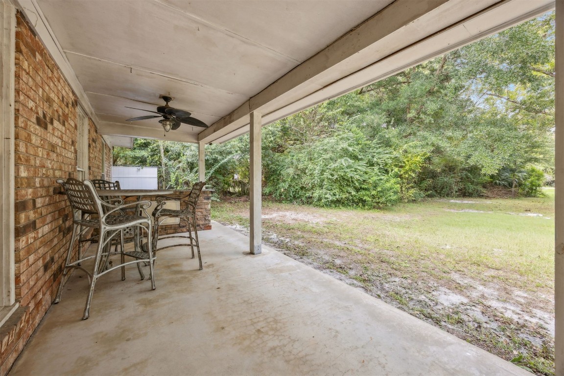 86071 Jones Road Yulee, FL 32097 - Photo 7 of 44 a view of a porch with chairs and backyard