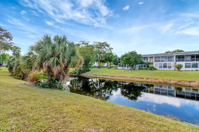 a front view of a house with a yard outdoor seating and mountain view
