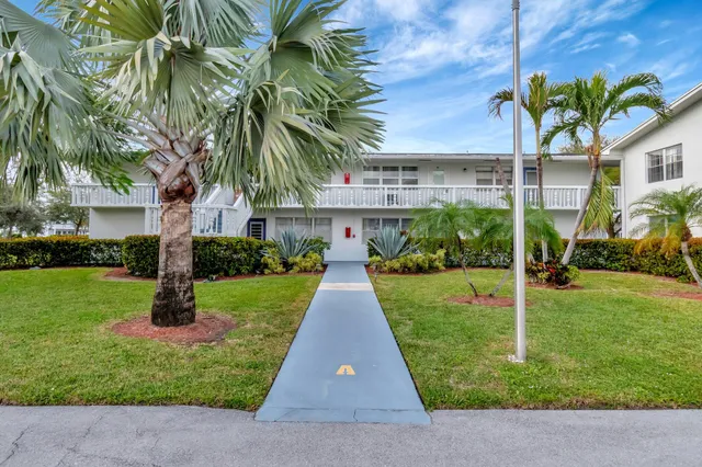 an aerial view of residential houses with outdoor space and river