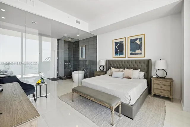 a bedroom with a bed and glass walk in closet