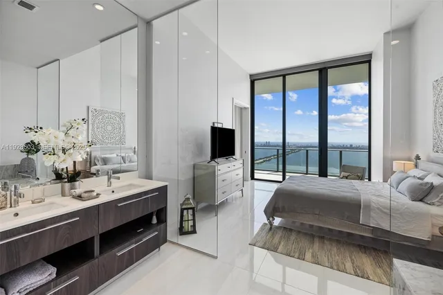 a spacious bedroom with a large bed and a large window