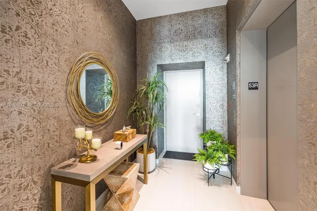 a bathroom with a sink mirror and a potted plant