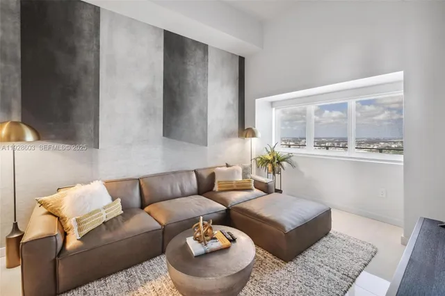 a living room with furniture and a large window