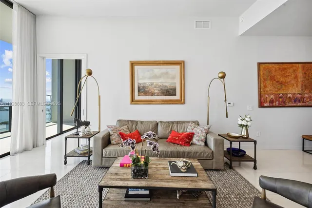 a living room with furniture and a potted plant