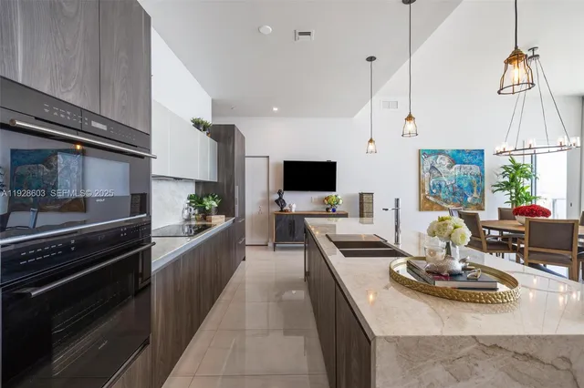 a kitchen with a stove a sink and a refrigerator