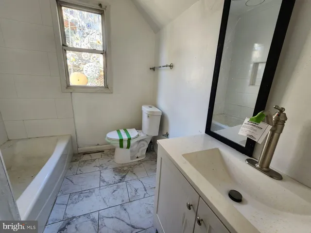 a bathroom with a sink and a window