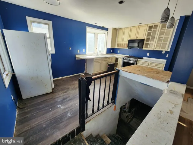 a kitchen with stainless steel appliances a refrigerator and a stove