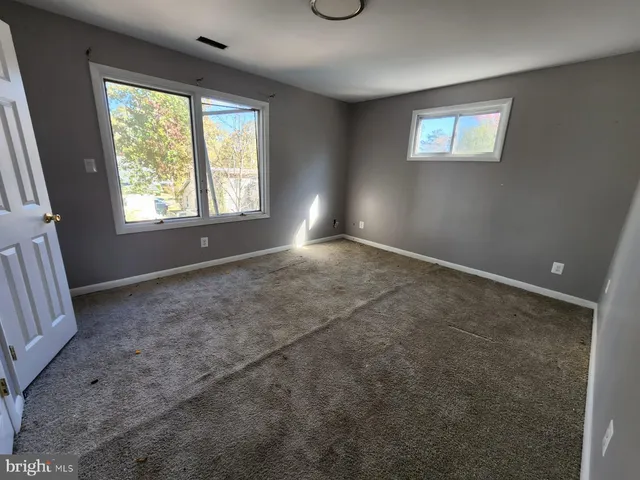 a bathroom with a bathtub sink and mirror