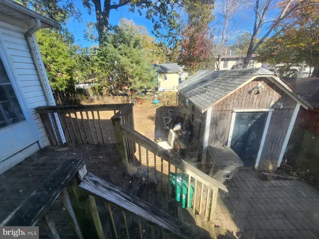 a view of a balcony with wooden fence and floor
