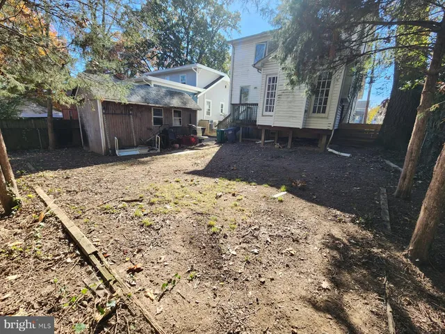 a view of a yard with a house in the background