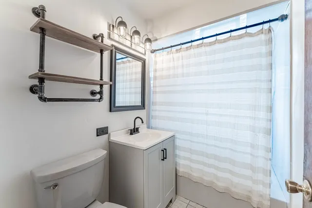 a bathroom with a sink a mirror and a shower