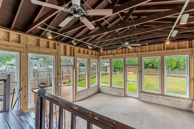 a view of a room with wooden floor and windows
