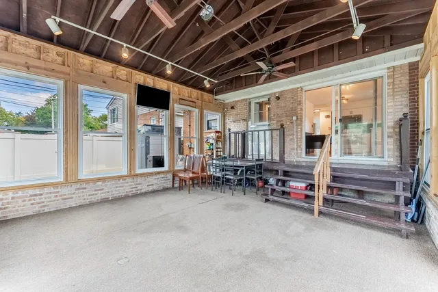 a view of porch with a table and chairs