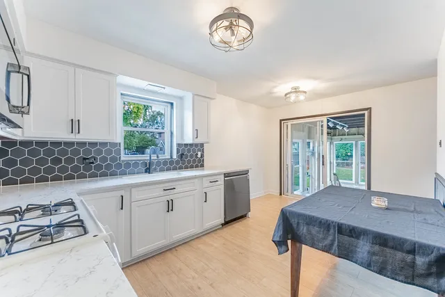 a kitchen with a stove a sink and a granite counter top