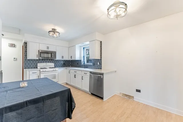 a kitchen with cabinets and window