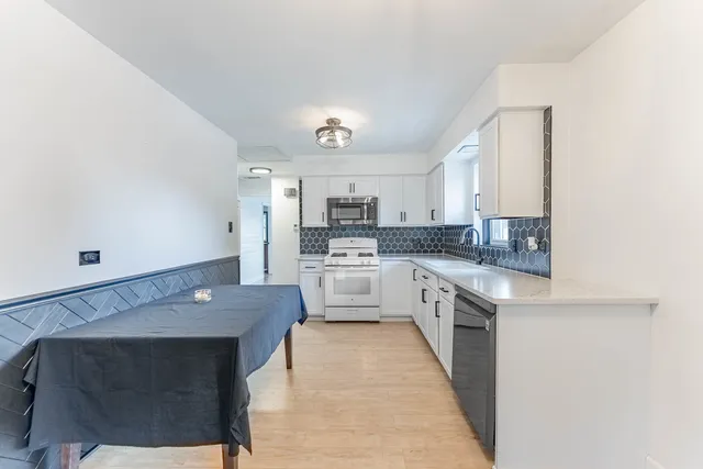 a large kitchen with cabinets and stainless steel appliances