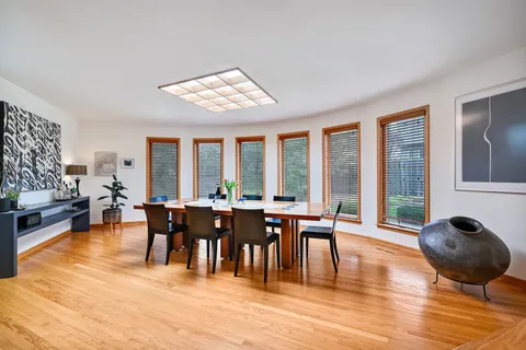 a view of a dining room with furniture window and wooden floor