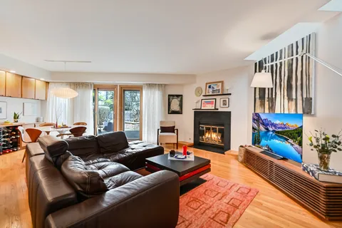 a living room with furniture fireplace and a large window