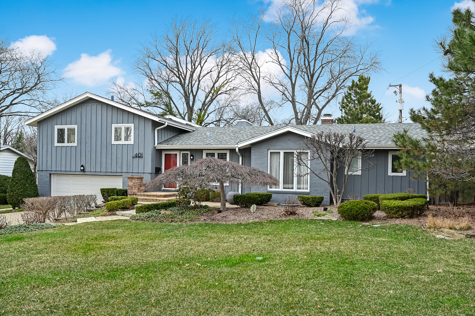 401 8th Place Hinsdale, IL 60521 - Photo 2 of 46 a front view of a house with a garden and trees