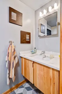 a bathroom with a sink vanity and mirror