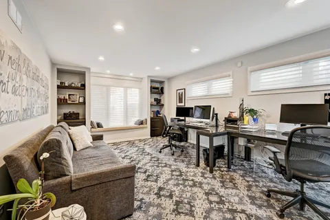 a living room with furniture a dining table and a piano table