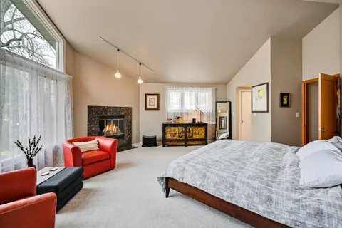 a view of kitchen with stainless steel appliances granite countertop a sink and a refrigerator