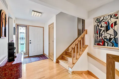 a view of an entryway with wooden floor