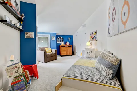 a bedroom with a bed couch and window