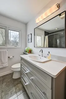 a view of a bathroom with sink and mirror