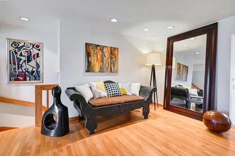 a living room with furniture and wooden floor