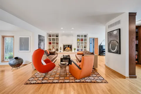 a living room with furniture a wooden floor and a window