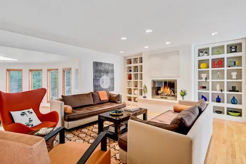 a living room with fireplace furniture and a flat screen tv