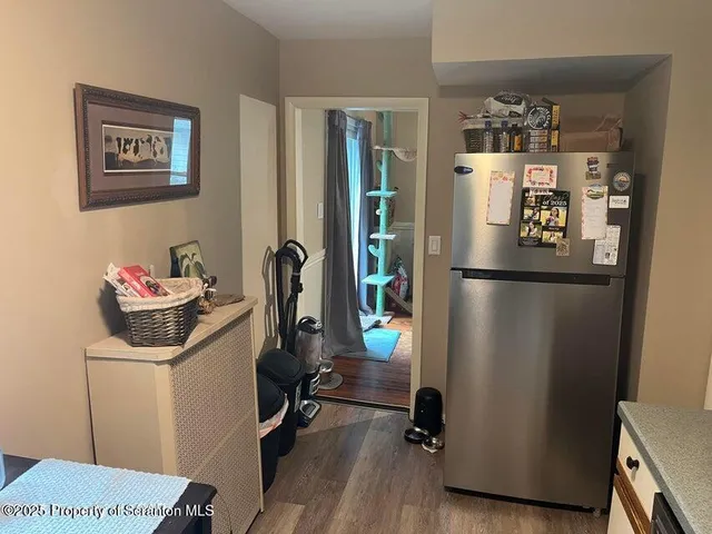 a kitchen with a refrigerator and cabinets