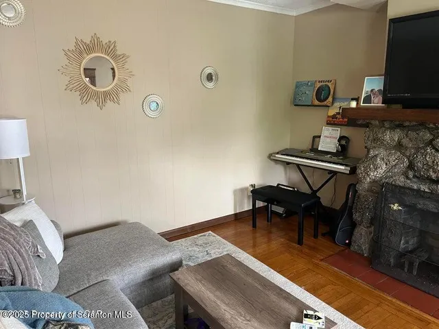 a living room with furniture and a flat screen tv
