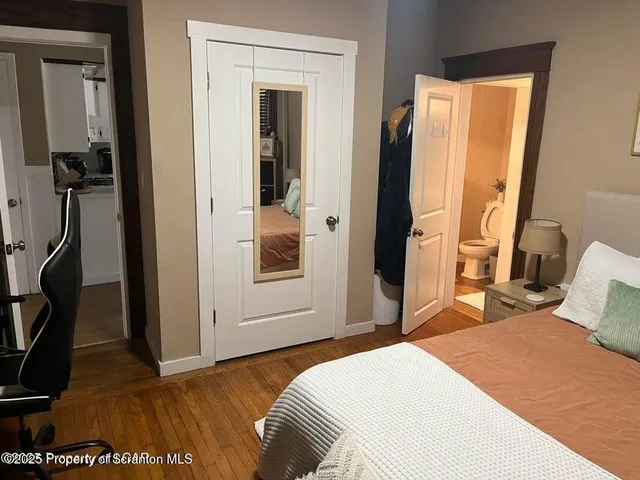 a bedroom with a bed and a mirror