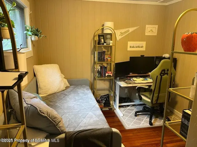 a bed sitting in a room next to a window