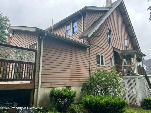 a view of small house with balcony