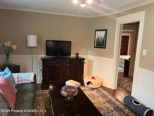 a living room with furniture and a flat screen tv