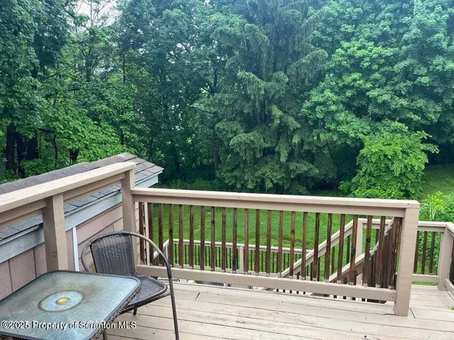 a view of a balcony with wooden floor