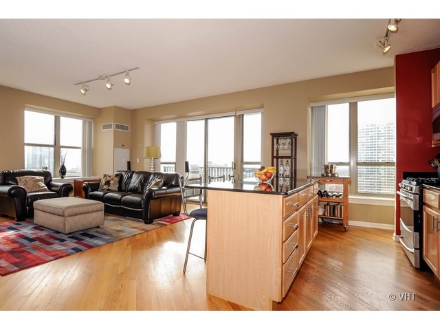 1717 South Prairie Avenue, Unit 1806 Chicago, IL 60616 - Photo 4 of 13 a living room with furniture large windows and kitchen view