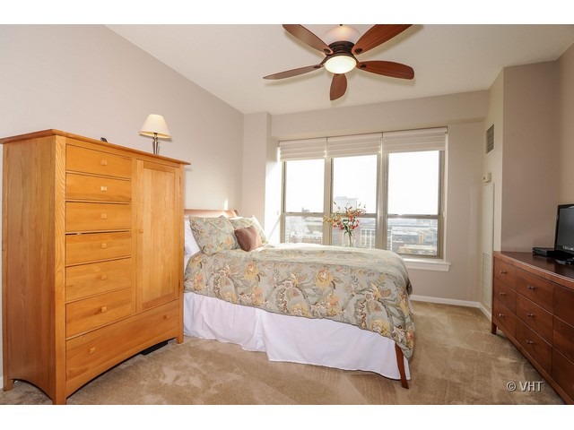 1717 South Prairie Avenue, Unit 1806 Chicago, IL 60616 - Photo 6 of 13 a bedroom with a bed and a dresser