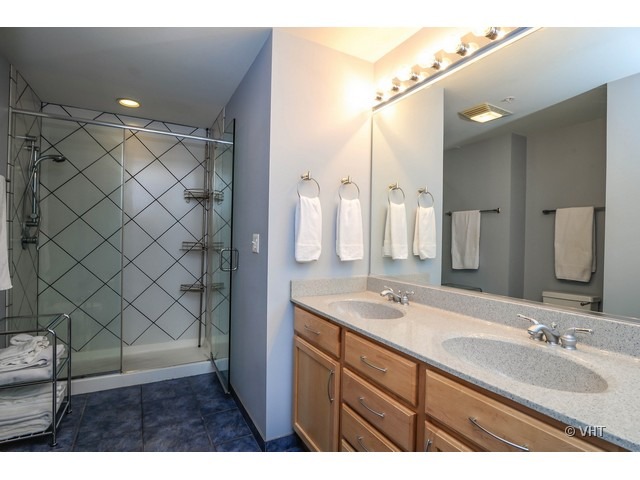 1717 South Prairie Avenue, Unit 1806 Chicago, IL 60616 - Photo 7 of 13 a bathroom with a double vanity sink mirror and shower