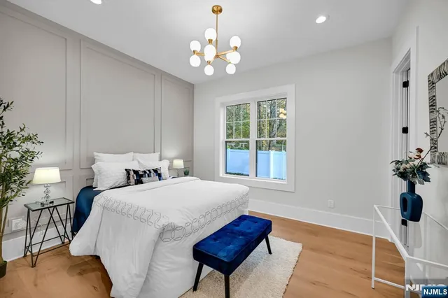 a bathroom with a sink a mirror a vanity and shower