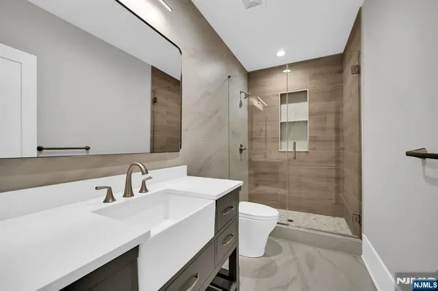 a view of a white house with a big yard and large tree