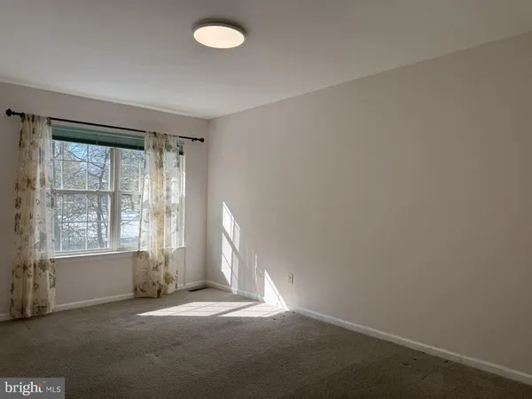 an empty room with a empty space and a window