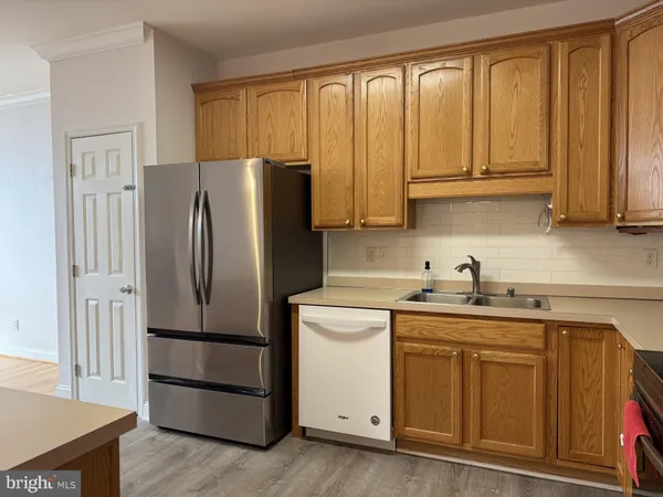 a kitchen with stainless steel appliances granite countertop a refrigerator sink and cabinets
